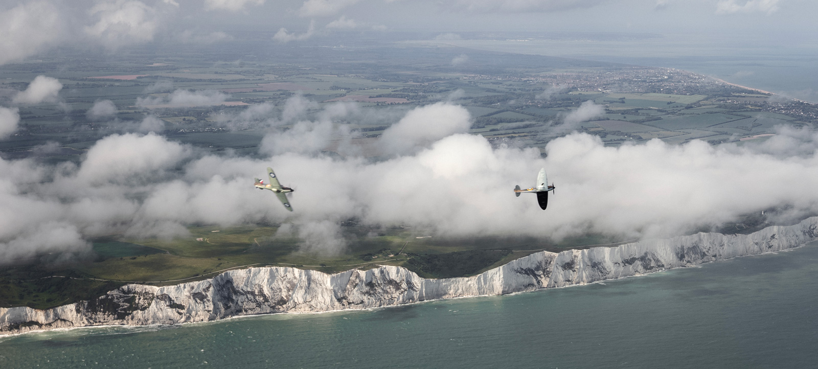 Seven historic aircraft flying together during the Aerial Collective Big Wing experience